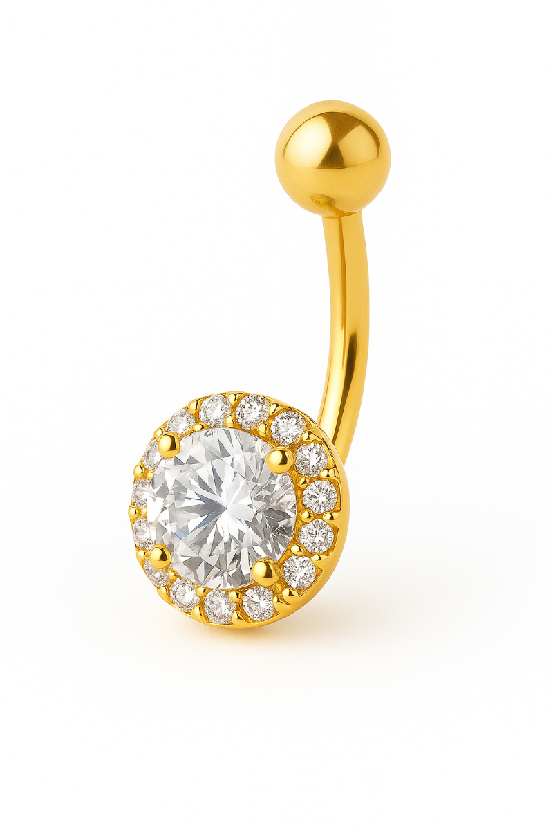 Gold belly button ring with a clear gemstone on a white background