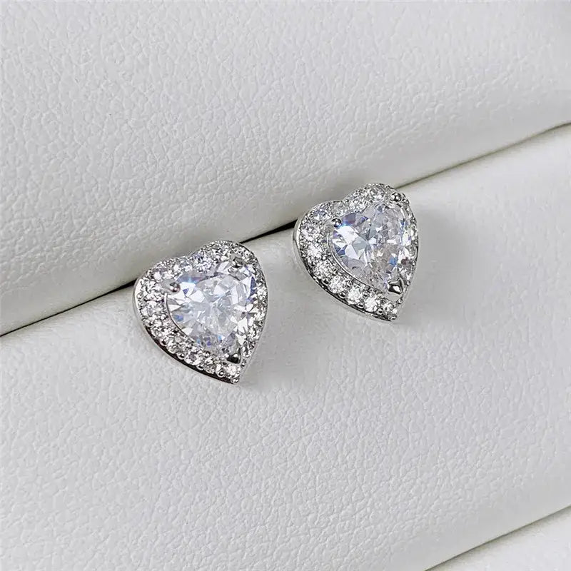 Heart-shaped crystal earrings on a white surface