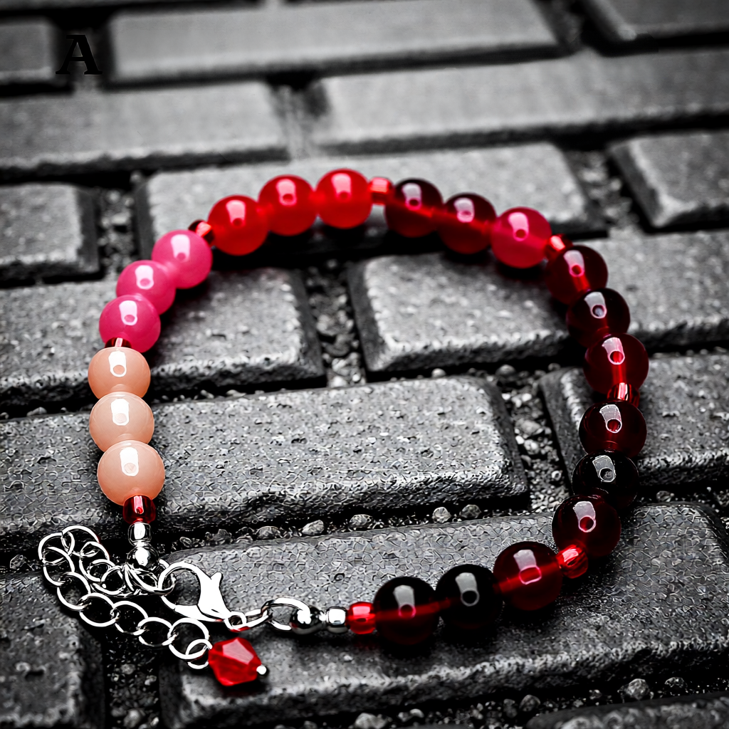 Beaded bracelet with red, pink, and brown beads on a textured surface
