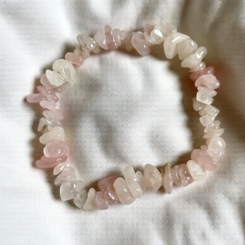 Pink stone bracelet on a white fabric background