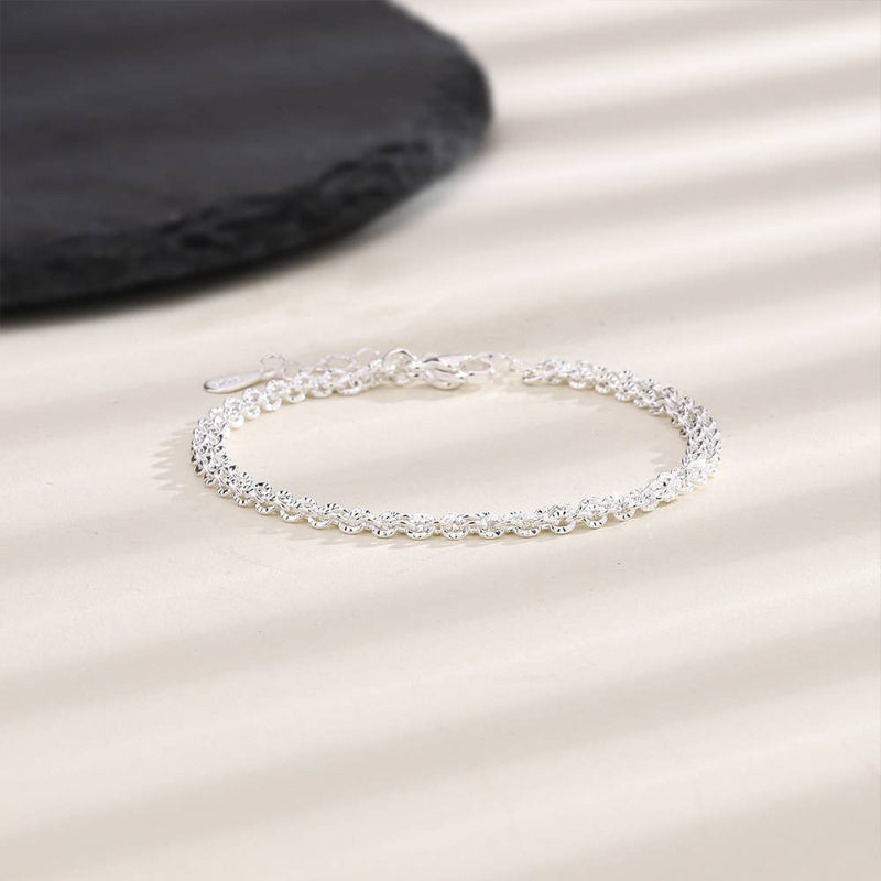 Silver bracelet on a beige fabric background