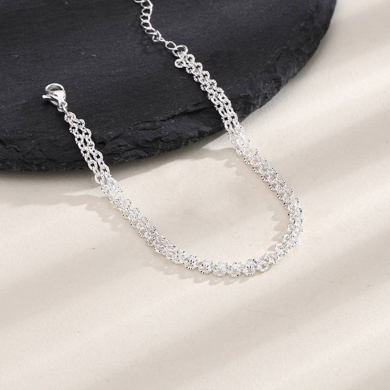 Silver chain bracelet on a stone surface